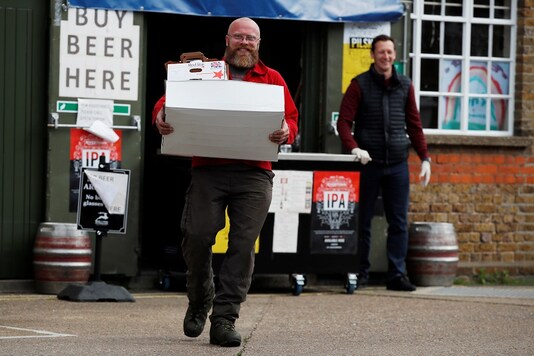 NHS staff with a food package at McMullen's brewery in Hertford, Natalie Payton and Lee Brooks offer a food collection service to all NHS staff, following the outbreak of the coronavirus disease (COVID-19), Hertford, Britain. (Reuters)
