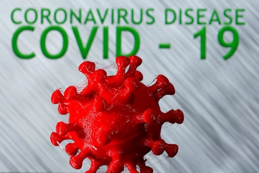 A 3D-printed coronavirus model is seen in front of the words coronavirus disease (COVID-19) on display in this illustration taken March 25, 2020. REUTERS/Dado Ruvic/Illustration/File Photo