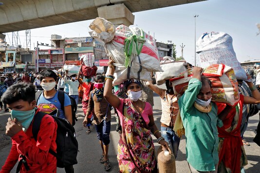 Migrant workers carrying their belongings walk back to their shelter after they heard that no train is scheduled for today to their home state of central Chhattisgarh, after a limited reopening of India's giant rail network following a nearly seven-week lockdown to slow the spread of the coronavirus disease (COVID-19), in Ahmedabad, India, May 17, 2020. REUTERS/Amit Dave
