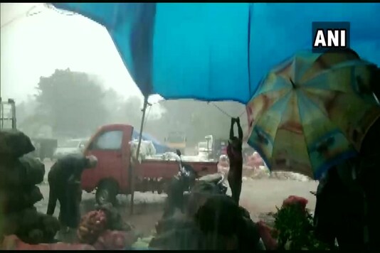 Fruits and vegetables kept at the Agricultural Produce Market Committee (APMC) yard in Baikampady was washed away. (Credit: ANI Twitter)
