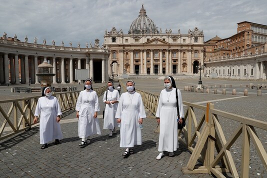 Nuns walk on the day of St Peter's Basilica's full reopening as the Vatican eases measures put in place during the coronavirus disease (COVID-19) outbreak, at the Vatican, May 18, 2020. REUTERS/Remo Casilli - RC2XQG99JVVZ