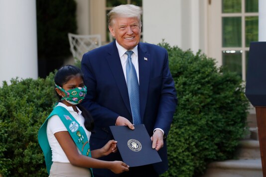 President Donald Trump poses for a photo with Girl Scout Troop 744 member Sravya Annappareddy during a presidential recognition ceremony in the Rose Garden of the White House, Friday, May 15, 2020, in Washington. (AP Photo/Alex Brandon)


