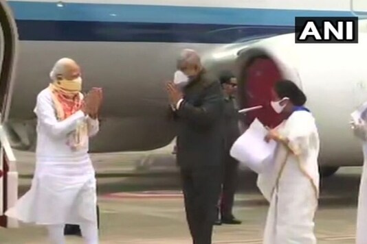 Prime Minister Narendra Modi being received by Governor Dhankar, CM Mamata Banerjee at Kolkata Airport. (Credits: ANI)