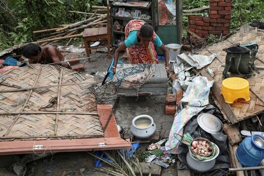 Residents salvage their belongings from the rubble of a damaged house in the aftermath of Cyclone Amphan, in South 24 Parganas district in the eastern state of West Bengal. (Reuters/Rupak De Chowdhuri)
