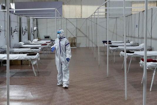 A woman wearing a protective suit is seen inside a hospital that has been constructed to treat patients who test positive for Covid-19 in Mumbai. (REUTERS) 