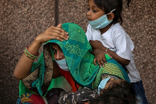A migrant family waits to get registered before boarding a train in Delhi to their home state of eastern Bihar. (Reuters)