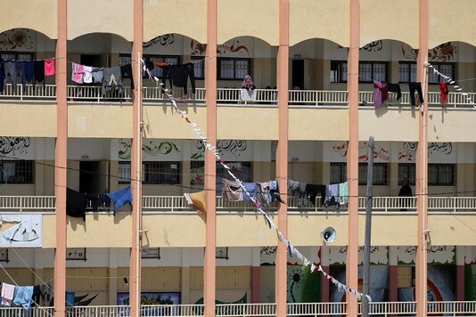FILE PHOTO: A Palestinian woman looks out from a school used as a quarantine facility amid concerns about the spread of the coronavirus disease (COVID-19), in the southern Gaza Strip April 23, 2020. REUTERS/Ibraheem Abu Mustafa