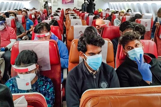 Flyers sit shoulder to shoulder in a repatriation flight. (Photo: PTI)