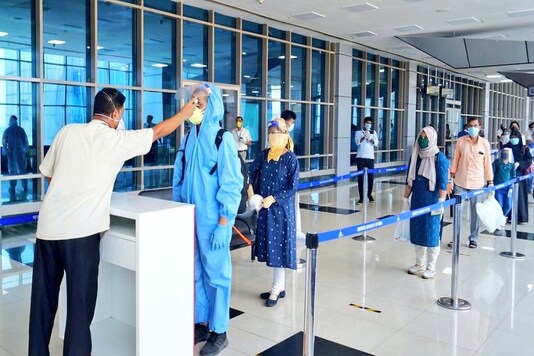 Passengers get checked for temperature at Mumbai airport on Monday. (Credit: Twitter)