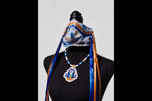A Navajo-inspired PPE mask and necklace created by Brighid Pulskamp is displayed in La Habra, California on May 14, 2020. The mask and necklace will be auctioned for the UCLA American Indian Alumni Association’s scholarship fund. (Adam Amengual/The New York Times) 