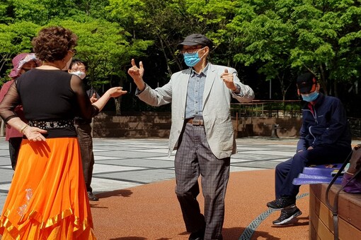 South Korean seniors wearing protective masks dance at park after their daytime discotheque 'colatec' closed amid the coronavirus disease (COVID-19) outbreak in Seoul. (Reuters)