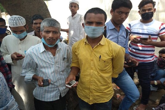 Migrant workers gather at KG Police Station in Tannery Road after a train to Bihar got cancelled. (Image credit: Twitter@aicctukar)