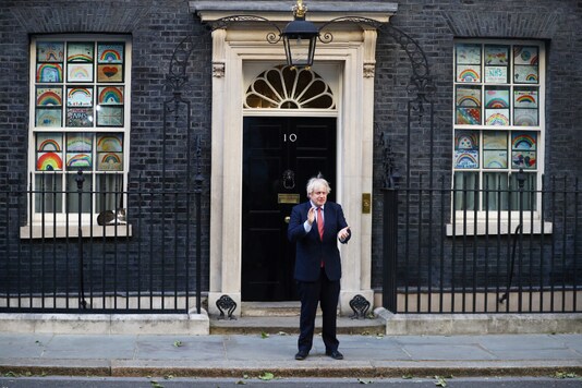 Britain's Prime Minister Boris Johnson applauds outside 10 Downing Street during the last day of the Clap for our Carers campaign in support of the NHS, following the outbreak of the coronavirus disease (COVID-19), in London, Britain, May 28, 2020. REUTERS/Hannah Mckay
