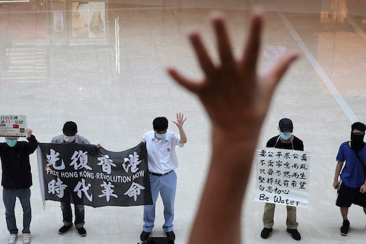 Protesters gesture with five fingers, signifying the Protesters gesture with five fingers, signifying the