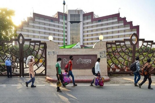 Migrant workers walk past Delhi Secretariat on May 11 (Photo Credits: PTI)
