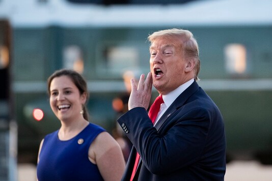 President Donald Trump speaks with reporters as he steps off Air Force One as he returns at Andrews Air Force Base, Md. (AP Photo/Alex Brandon)
