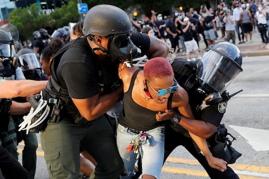 A protester is detained by police officers during a protest against the death in Minneapolis police custody of George Floyd, in Atlanta, U.S., May 30, 2020. (REUTERS/Shannon Stapleton)
