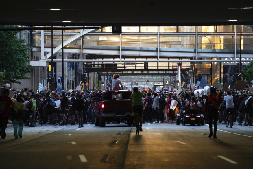  Demonstrators march through downtown Minneapolis, protesting the death of George Floyd in police custody Monday. (Mark Vancleave/Star Tribune via AP)