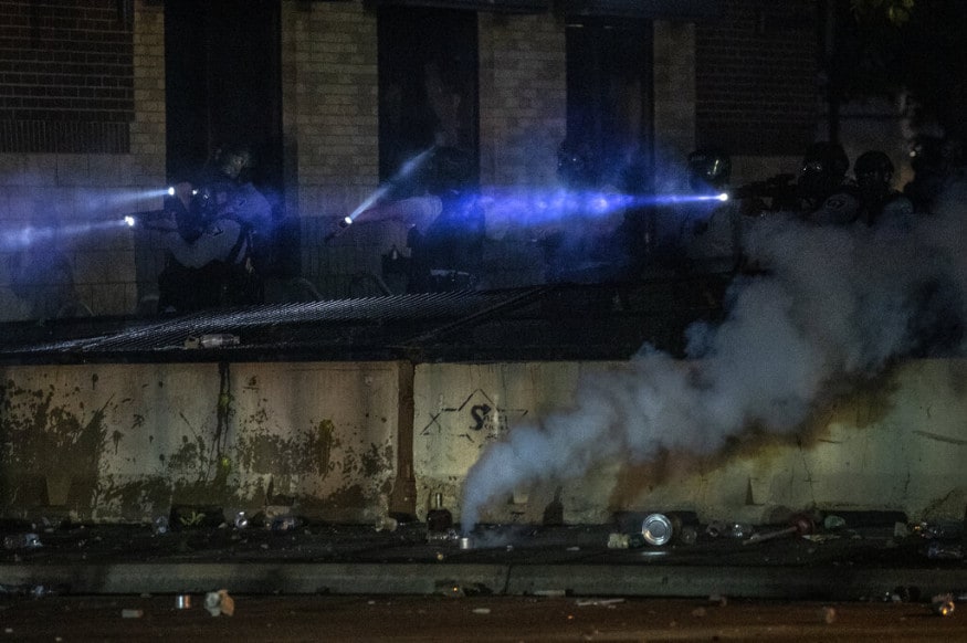  Minneapolis police at the 3rd Precinct looks out from a building, in Minneapolis during protests over the Monday death of George Floyd in police custody. (Carlos Gonzalez/Star Tribune via AP)