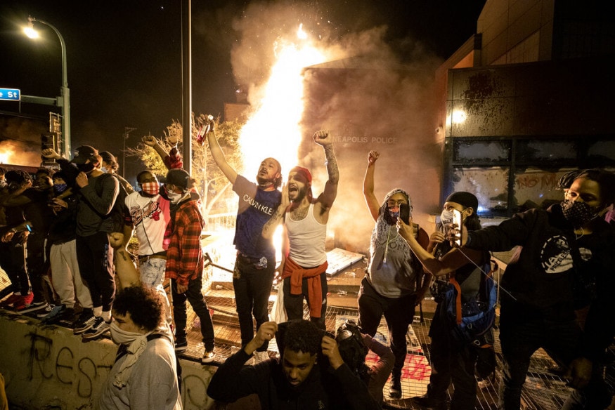  People stand outside the Minneapolis police 3rd Precinct building after fires were set at the building, in Minneapolis, during demonstrations over the death George Floyd in Minneapolis police custody. (Carlos Gonzalez/Star Tribune via AP)