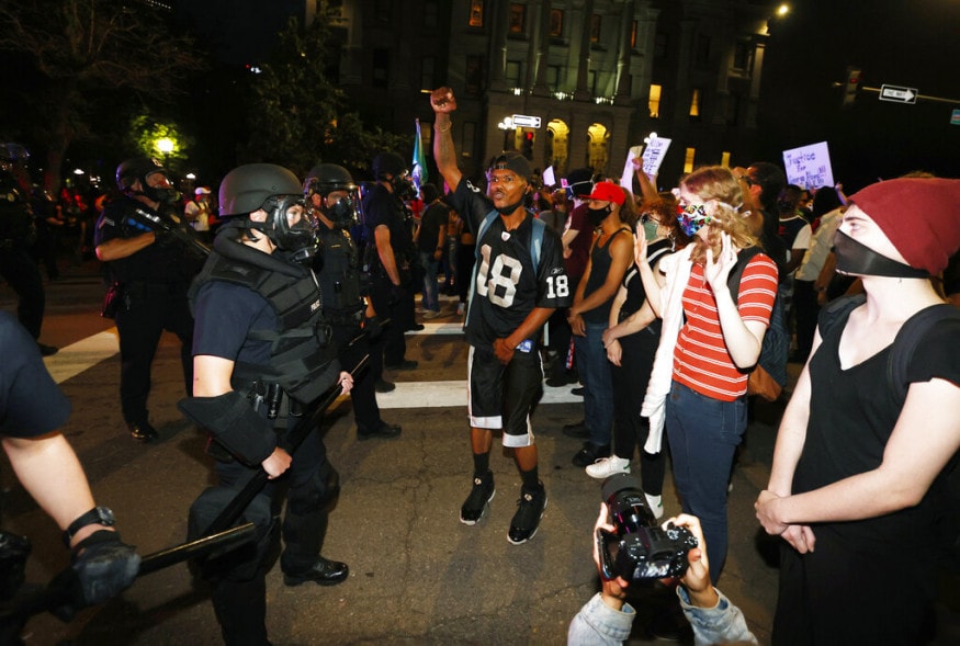  Denver police face off with protesters outside the State Capitol over the death of George Floyd, a handcuffed black man in police custody in Minneapolis, in Denver. (Image: AP)