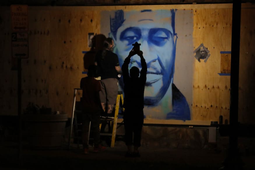  An artist creates an image of George Floyd, in Minneapolis. (Image: AP)