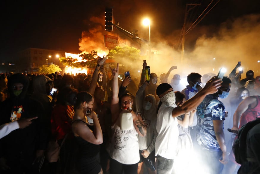  Protesters gather in front of the burning 3rd Precinct building of the Minneapolis Police Department, in Minneapolis. (Image: AP)