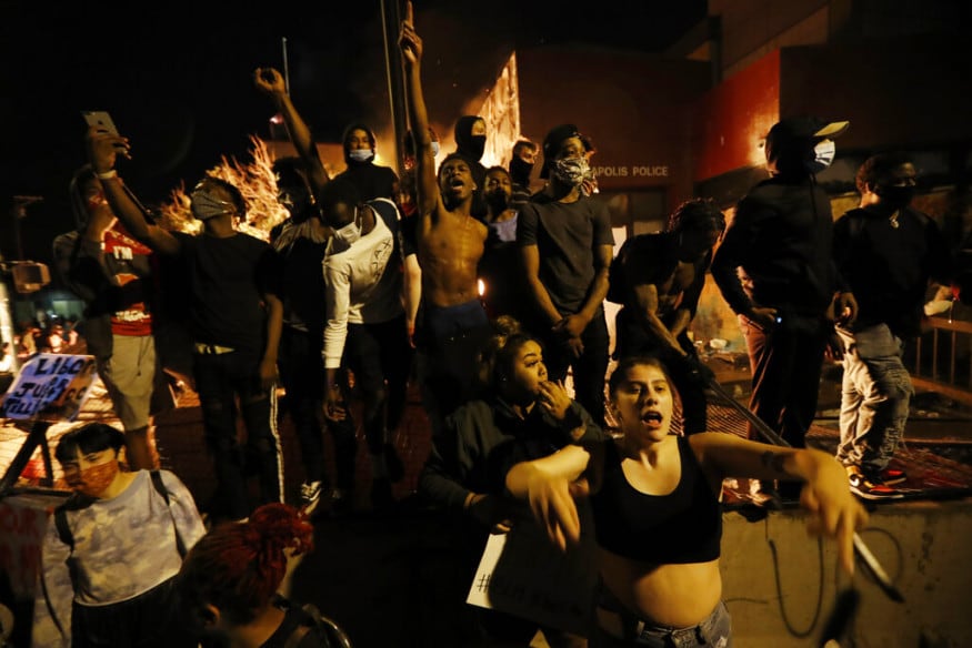  Protesters gather in front of the burning 3rd Precinct building of the Minneapolis Police Department, in Minneapolis. (Image: AP)