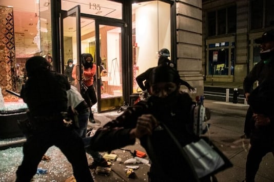 People take luxury products from a smashed storefront during a protest against the death in Minneapolis police custody of George Floyd, in the Manhattan borough of New York City, US., May 31, 2020. Picture taken May 31, 2020. (REUTERS/Jeenah Moon) People take luxury products from a smashed storefront during a protest against the death in Minneapolis police custody of George Floyd, in the Manhattan borough of New York City, US., May 31, 2020. Picture taken May 31, 2020. (REUTERS/Jeenah Moon)
