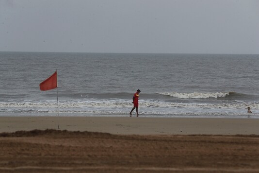 A life guard walks at Juhu beach in an Arabian Sea in Mumbai, India, Tuesday, June 2, 2020. (AP Photo/Rafiq Maqbool)