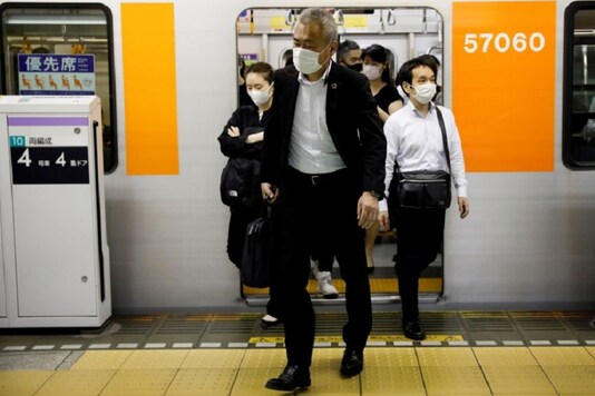 FILE PHOTO: Passengers wearing protective masks get off a subway train at  amid the coronavirus disease (COVID-19) outbreak. REUTERS/Kim Kyung-Hoon