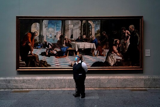 FILE PHOTO: An employee stands next to Tintoretto's painting 'Christ washing the disciples' feet' as the Prado museum reopens to public under strict social distance measures, amid the coronavirus disease (COVID-19) outbreak, in Madrid, Spain, June 6, 2020. REUTERS/Juan Medina/File Photo