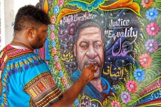 Haider Ali with his artwork.