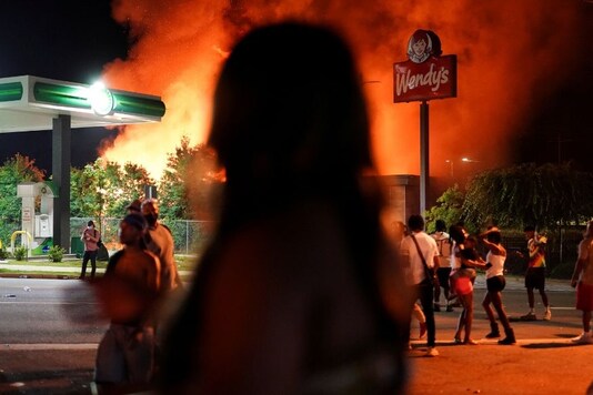 People watch as a Wendy’s burns following a rally against racial inequality and the police shooting death of Rayshard Brooks, in Atlanta, Georgia, US. (Reuters)