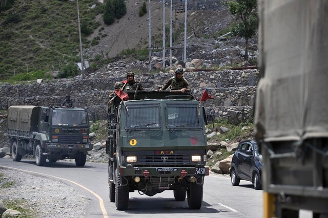An Indian army convoy moves on the Srinagar- Ladakh highway at Gagangeer, north-east of Srinagar. (PTI)