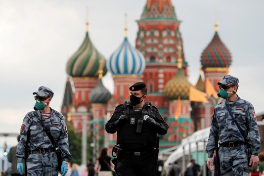 FILE PHOTO: Russian law enforcement officers wearing protective face masks, used as a preventive measure against the spread of the coronavirus disease (COVID-19), walk at the annual Red Square Book Fair in central Moscow, Russia June 6, 2020. REUTERS/Shamil Zhumatov/File Photo