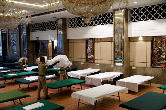 For representation: 8Civil defence volunteers prepare beds inside a banquet hall used for weddings after it was temporarily converted into a makeshift quarantine facility for patients diagnosed with COVID-19 in New Delhi. (Reuters)
