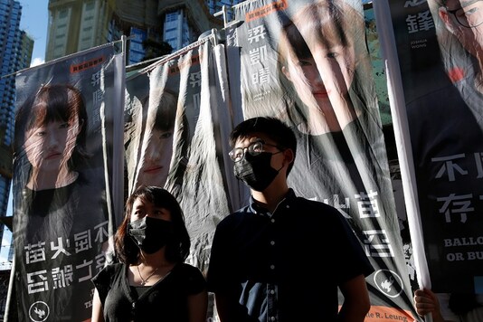 Pro-democracy activist Joshua Wong announces his plans to run for legislature next to pro-democracy district councillor Jannelle Leung, in Hong Kong, China June 19, 2020. (Image: REUTERS)
