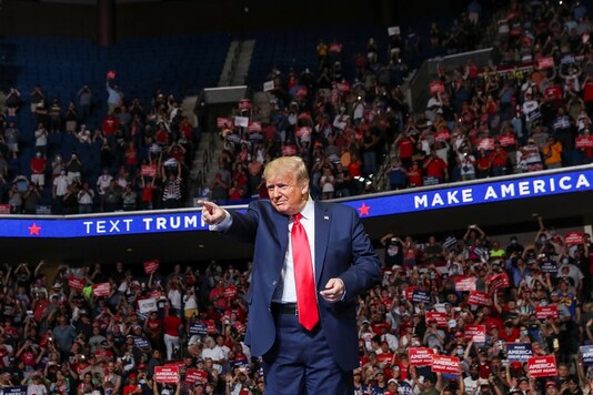 U.S. President Donald Trump points at the crowd as he enters his first re-election campaign rally in several months in the midst of the coronavirus disease (COVID-19) outbreak, at the BOK Center in Tulsa, Oklahoma, U.S., June 20, 2020. REUTERS/Leah Millis