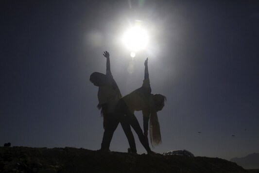 Afghan enthusiasts women perform yoga to mark International Yoga Day during the COVID-19 pandemic lockdown, on the outskirts of Kabul, Afghanistan. (Image: AP)