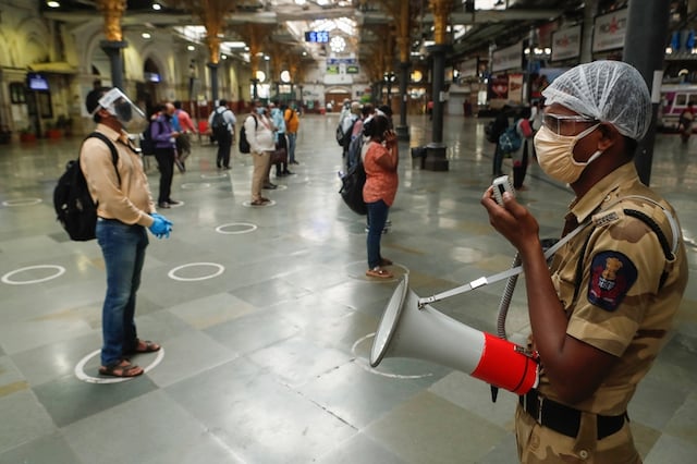 For representation: A railway police official makes an announcement on a loudspeaker telling commuters to stand inside the designated circles to maintain social distancing as they wait to board a train at a railway station after some restrictions were lifted during a lockdown to slow the spread of the coronavirus disease (COVID-19) in Mumbai, India, June 22, 2020. (Image: REUTERS)
