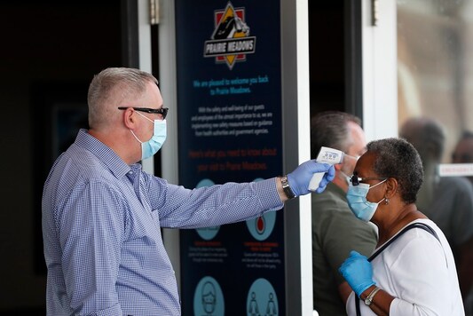 A women has her temperature taken before entering Prairie Meadows Casino, Monday, June 15, 2020, in Altoona, Iowa. (AP Photo/Charlie Neibergall)