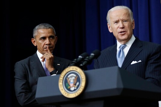 File photo of former US President Barack Obama listening to the then vice president Joe Biden.