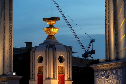 A construction crane is pictured next to the Democracy monument in Bangkok, Thailand, May 22, 2020. REUTERS/Athit Perawongmetha
