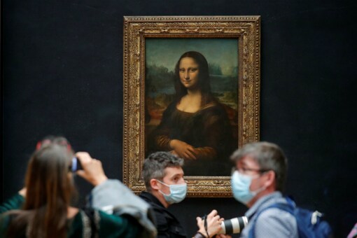 File Photo: Mediapersons take photos of the Mona Lisa as the Louvre Museum prepares to reopen after Covid-19. (Reuters)