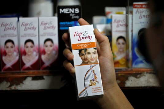 A customer picks up 'Fair & Lovely' brand of skin lightening product from a shelf in a shop in Ahmedabad. (Image: Reuters)