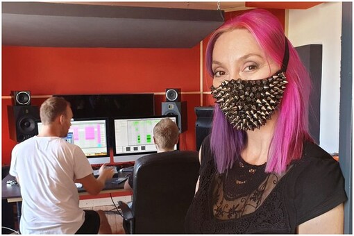 Belgian pop star Dana Rexx poses with a mask inside a studio | Image credit: Reuters