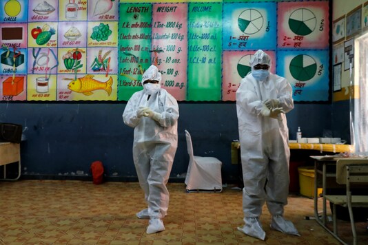 Medical workers get ready at a school which was converted into a Covid-19 testing facility. (Reuters)