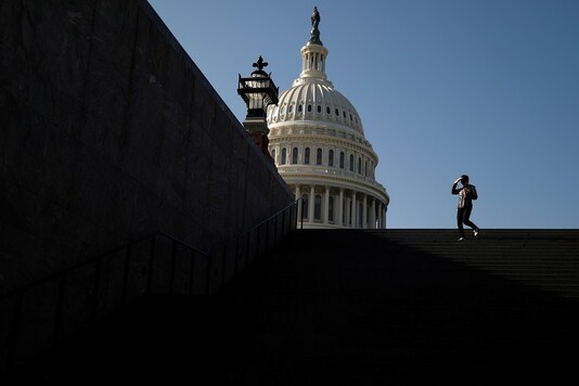 A visitor walks outside of the US Capitol. (Reuters)