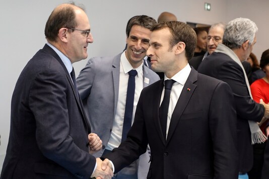 French President Emmanuel Macron shakes hands with Interministerial Delegate for the Olympic and Paralympic Games 2024 Jean Castex (L) flanked by President of the Paris Organising Committee of the 2024 Olympic and Paralympic Games Tony Estanguet during the inauguration of a new handball complex in Creteil, on the outskirts of Paris, France January 9, 2019. (Ludovic Marin/Pool via REUTERS/File Photo)